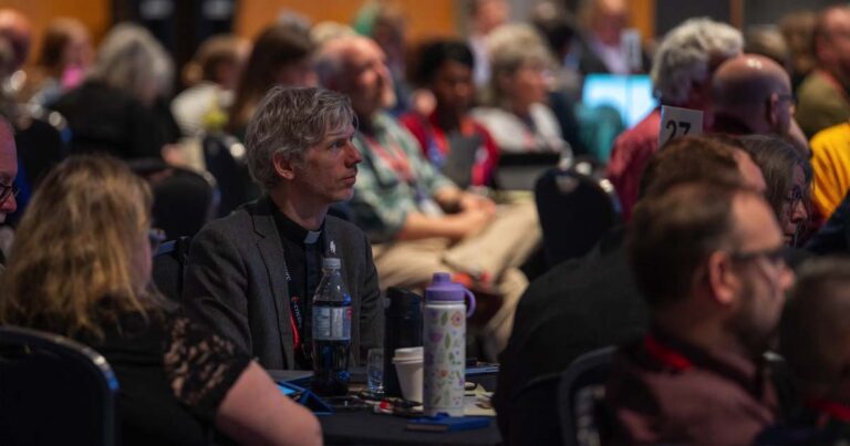 People listening to debate