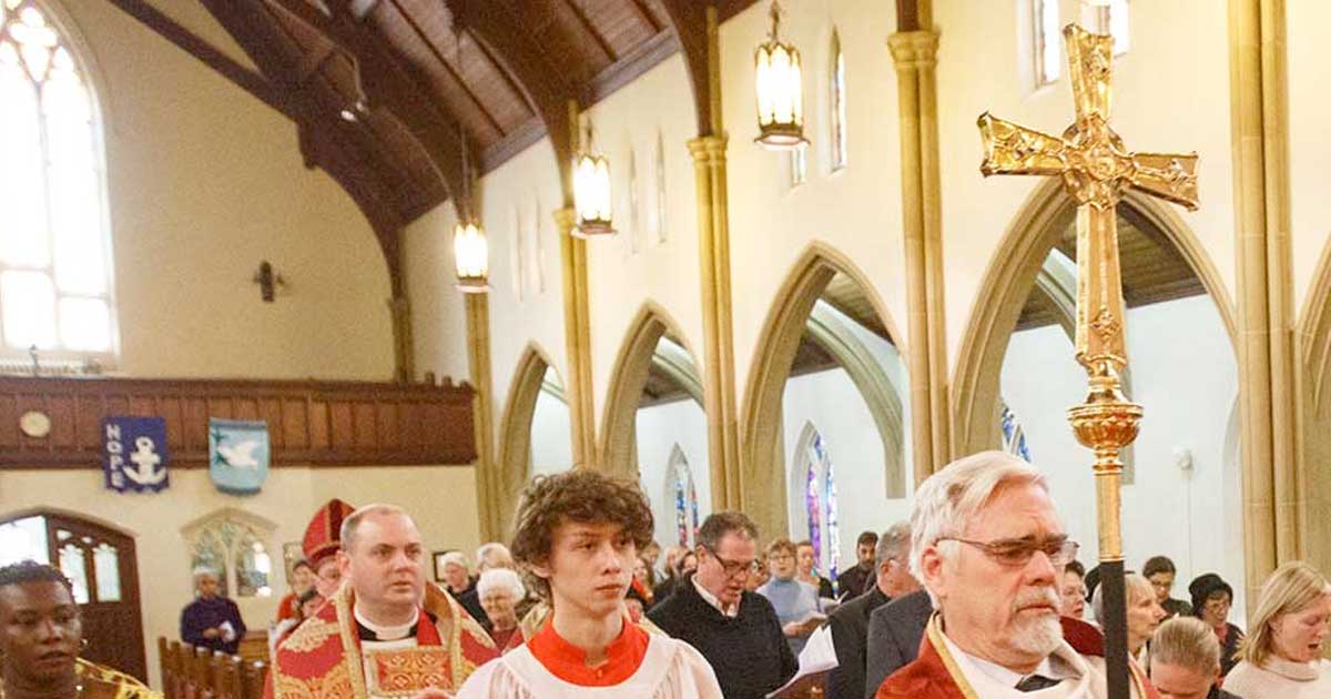 Photo of a church focusing on the procession with the Primatial Cross